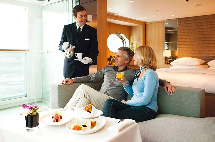 Couple having breakfast in their suite on board a river cruise