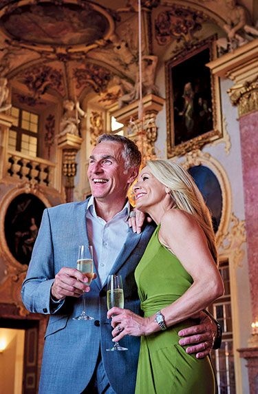 Guests holding champagne in the ornate Palace of Rastatt ballroom